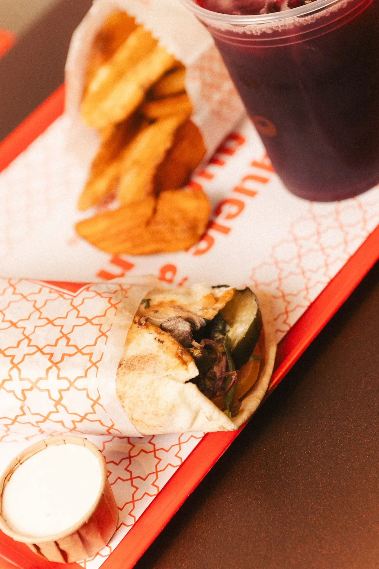 Shawarma de carne com batatas e chá gelado na bandeja
